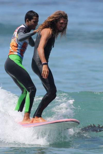 Pro Surfer, Rob Machado, catching a ride with Rabelo during the film's production.